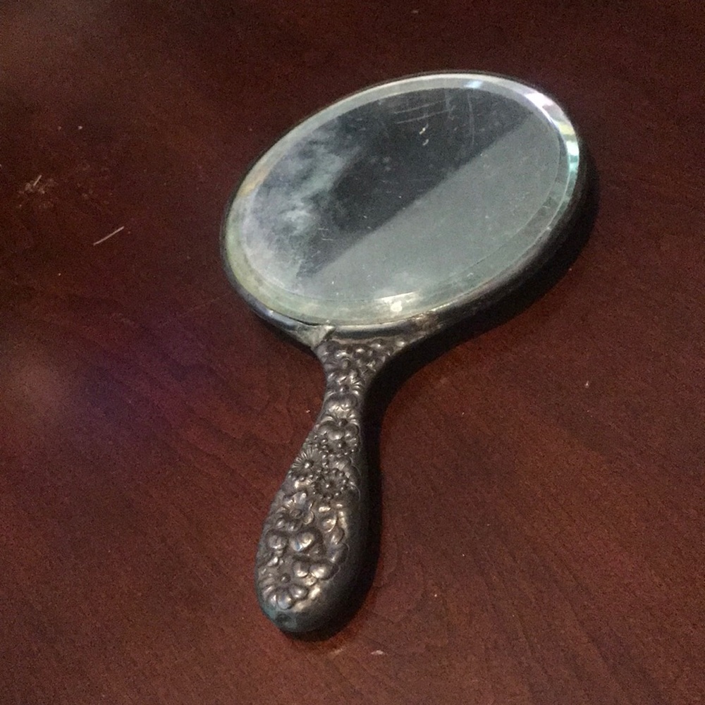 Vintage silver hand held mirror with raised flowers